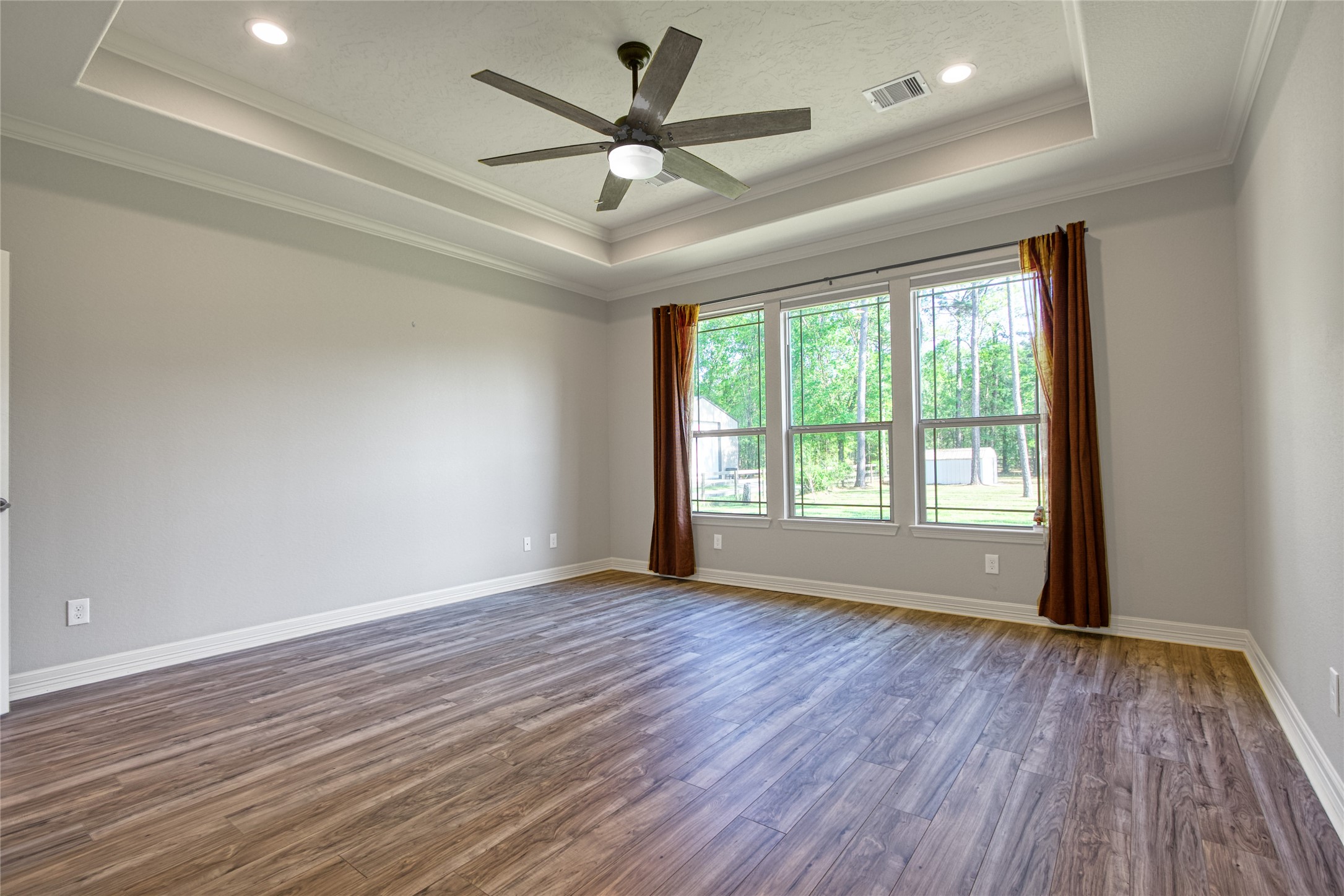 27684 Rio Blanco Drive Splendora, TX 77372 - Photo 13 of 31 an empty room with wooden floor ceiling fan and windows