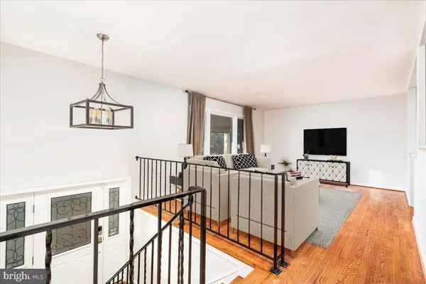a living room with furniture floor to ceiling window