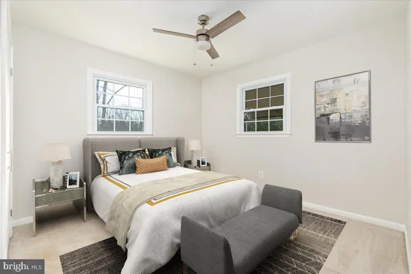 a bedroom with a bed couch and window