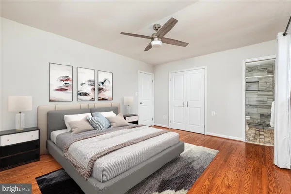 a bedroom with a large bed and a chandelier