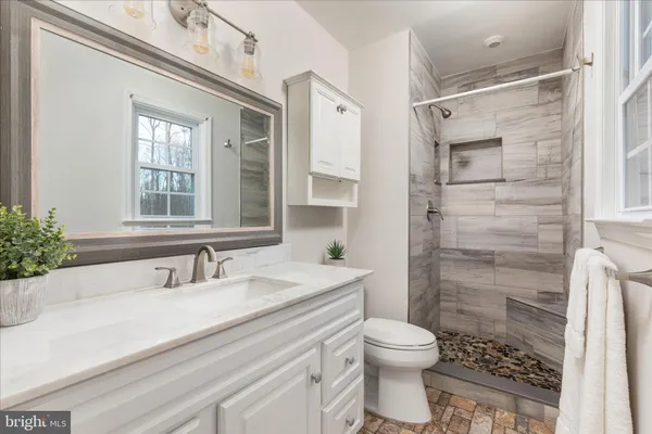 a bathroom with a sink toilet and shower
