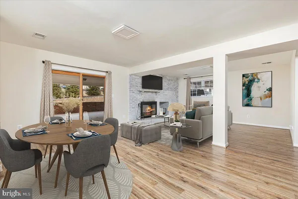 a living room with fireplace furniture and a wooden floor