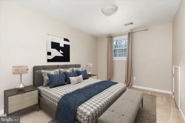 a bedroom with bed and window