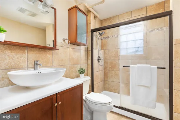 a bathroom with a sink toilet and shower