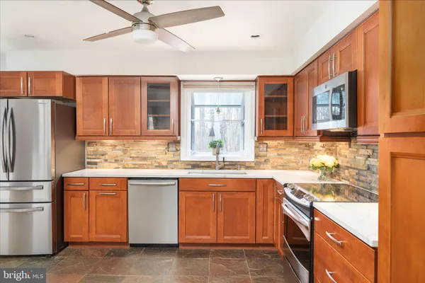 a kitchen with a sink stove and refrigerator