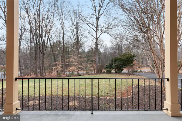 a balcony with couches and a potted plant on a table