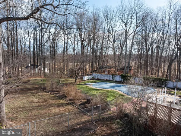 a view of a house with a door and wooden fence
