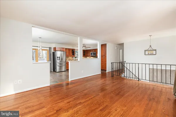 a view of a big room with wooden floor and windows
