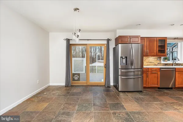 a kitchen with stainless steel appliances a refrigerator and a stove