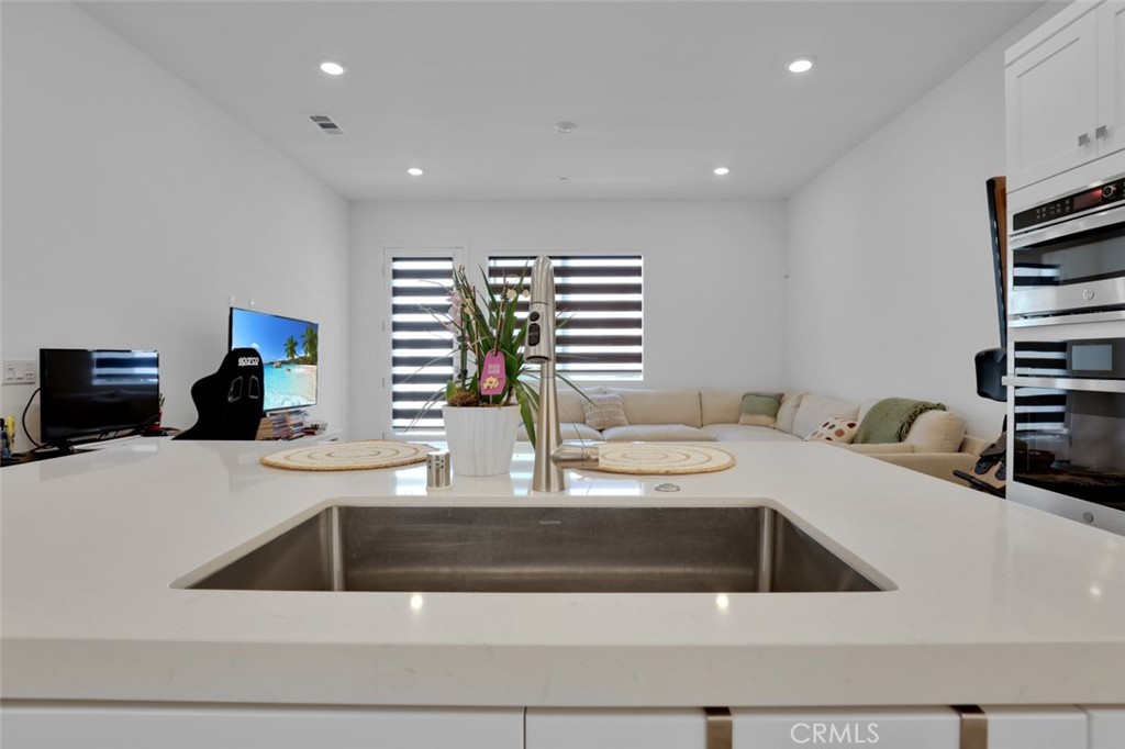 145 Sash Irvine, CA 92618 - Photo 20 of 20 a kitchen with a sink and a stove top oven with wooden floor