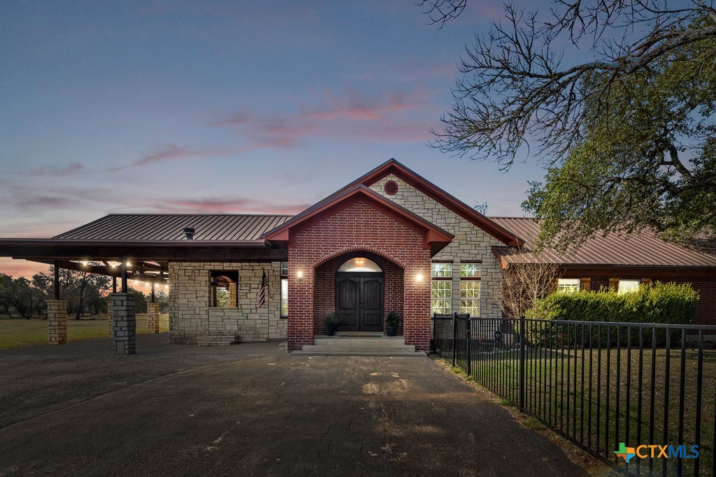 2795 Highway 290 Dripping Springs, TX 78620 - Photo 1 of 40 a front view of a house with a yard