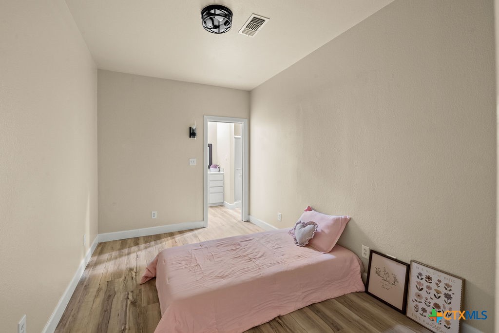 2795 Highway 290 Dripping Springs, TX 78620 - Photo 13 of 40 a bedroom with a bed and a window