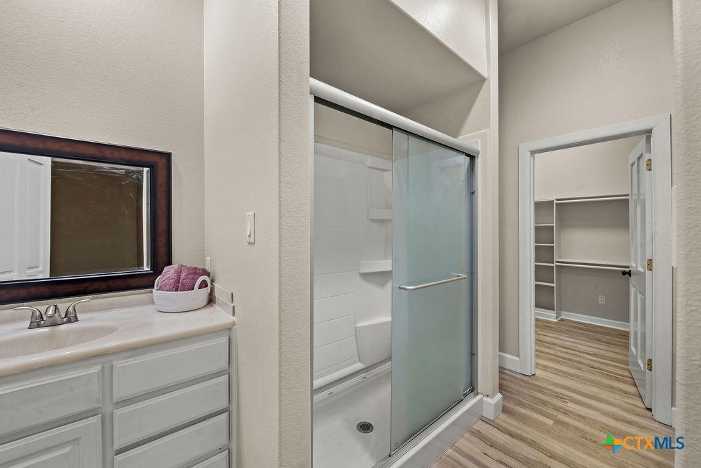 2795 Highway 290 Dripping Springs, TX 78620 - Photo 14 of 40 a bathroom with a shower sink and mirror
