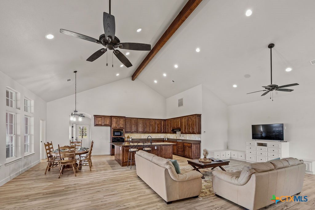2795 Highway 290 Dripping Springs, TX 78620 - Photo 2 of 40 a living room with furniture kitchen and a chandelier