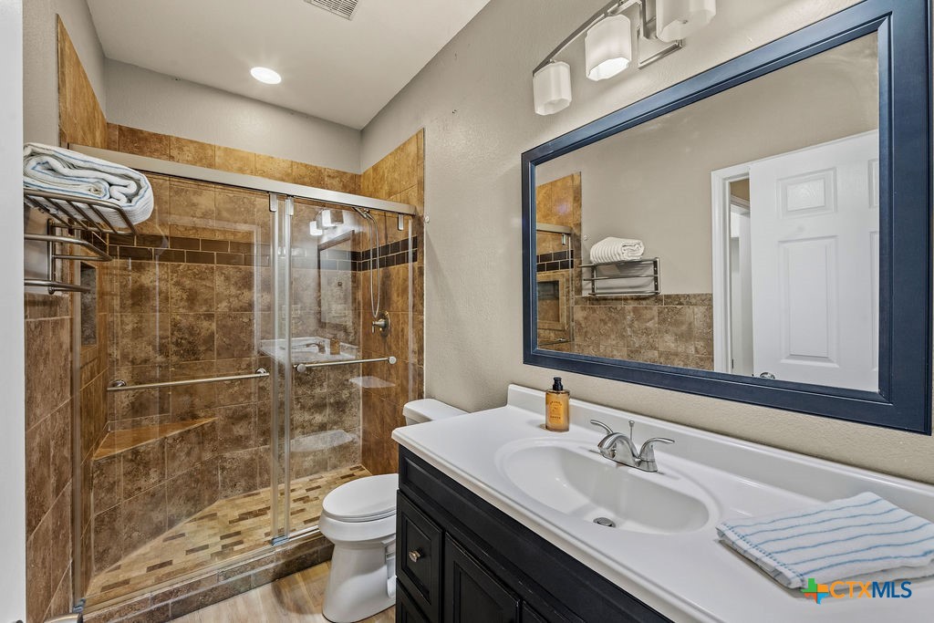 2795 Highway 290 Dripping Springs, TX 78620 - Photo 22 of 40 a bathroom with a sink a toilet and shower