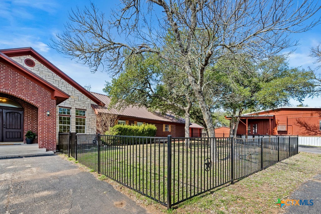 2795 Highway 290 Dripping Springs, TX 78620 - Photo 28 of 40 a view of a wrought iron fences in front of house