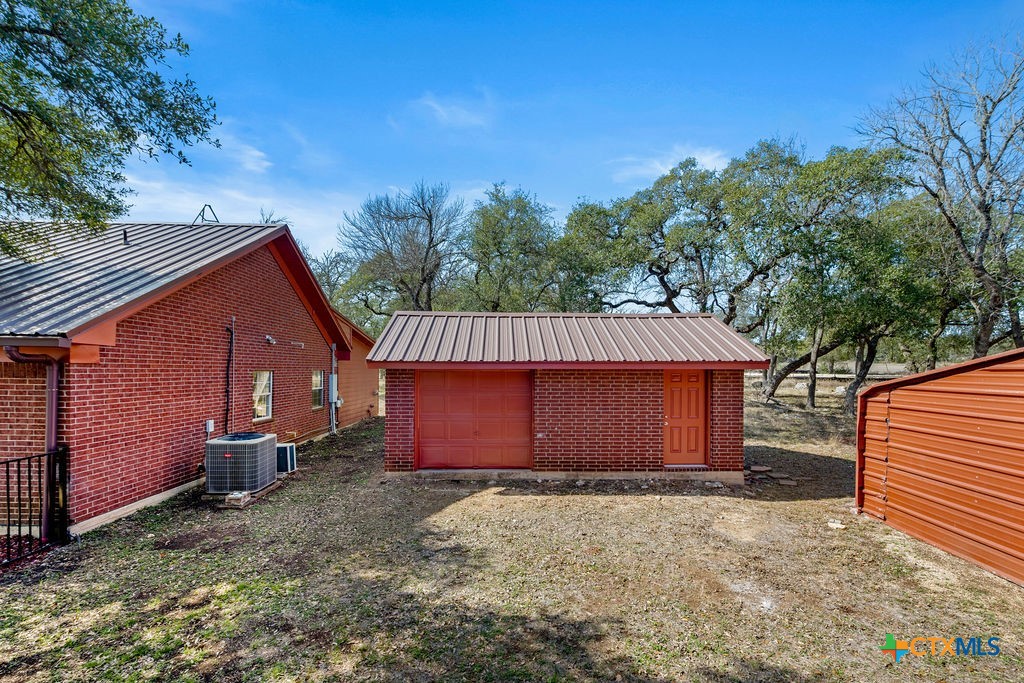 2795 Highway 290 Dripping Springs, TX 78620 - Photo 29 of 40 a front view of a house with a yard
