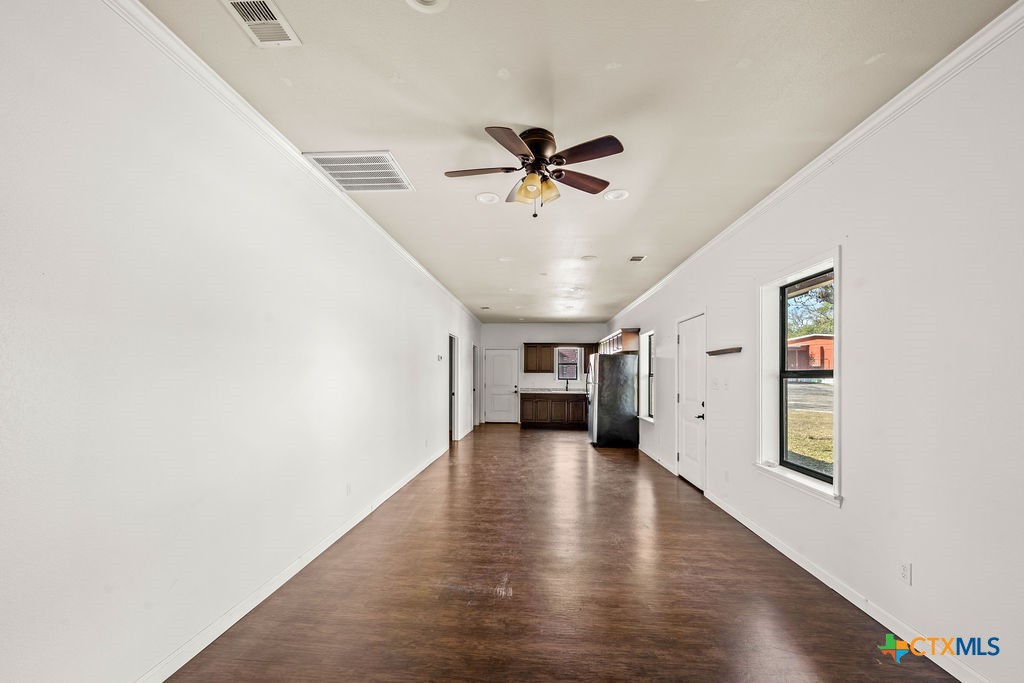 2795 Highway 290 Dripping Springs, TX 78620 - Photo 34 of 40 a view of a livingroom with wooden floor and a ceiling fan