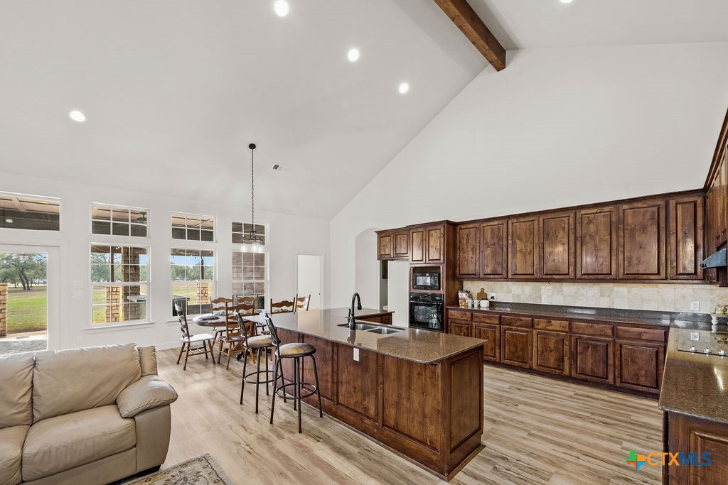 2795 Highway 290 Dripping Springs, TX 78620 - Photo 5 of 40 a living room with stainless steel appliances granite countertop furniture and a wooden floor