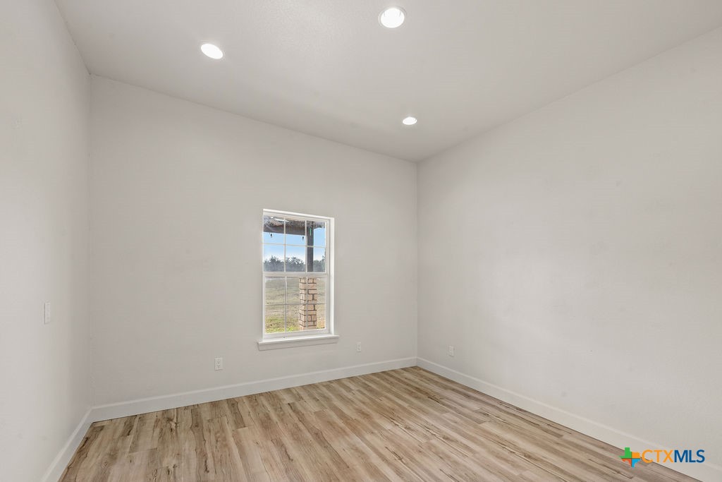2795 Highway 290 Dripping Springs, TX 78620 - Photo 8 of 40 an empty room with a window