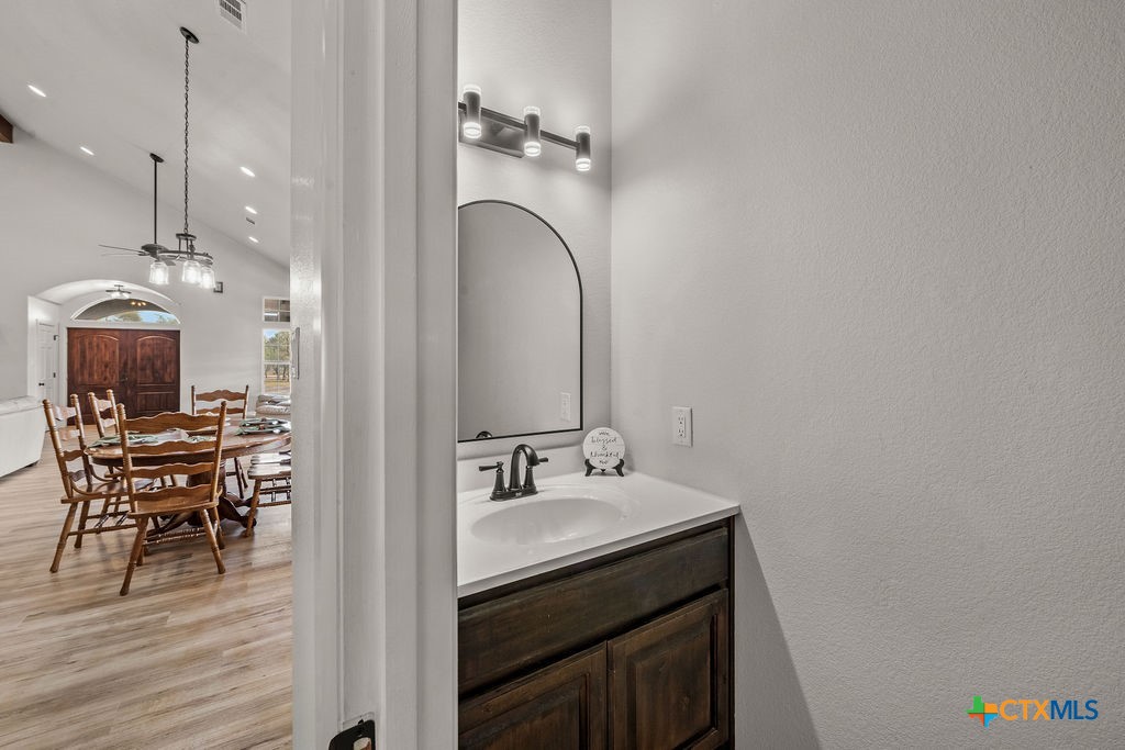 2795 Highway 290 Dripping Springs, TX 78620 - Photo 10 of 40 a en suite bathroom with a sink and a mirror