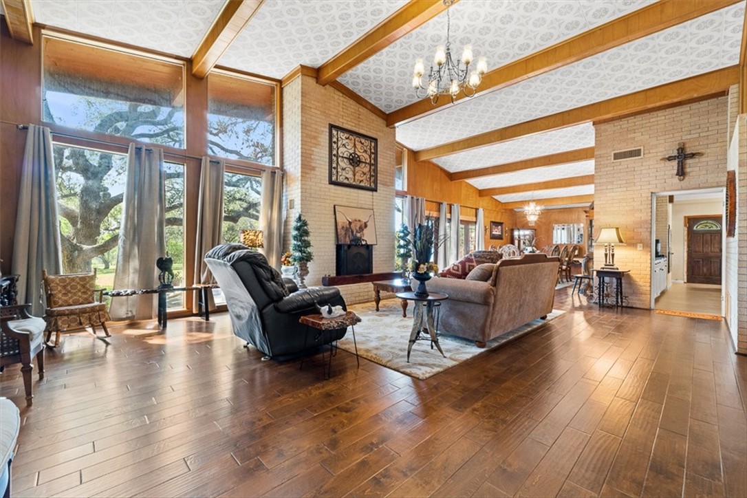 9675 County Road 325 Mathis, TX 78368 - Photo 11 of 29 a living room with furniture a large window and wooden floor