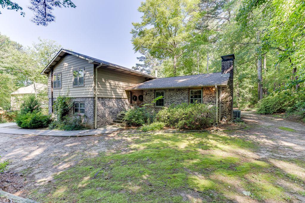 4541 Arcado Road Southwest Lilburn, GA 30047 - Photo 1 of 1 a front view of a house with a yard