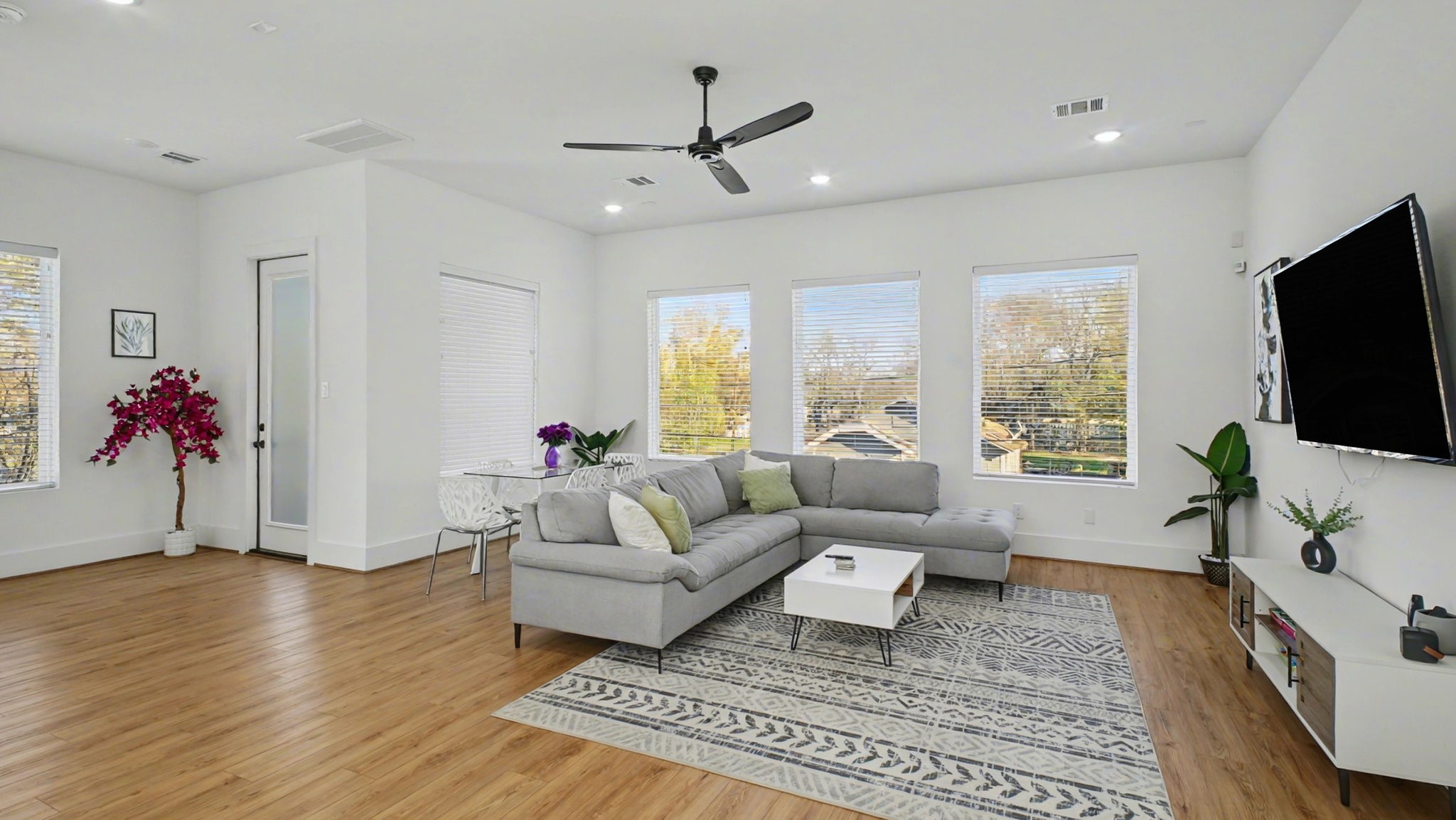 2802 Tierwester Street Houston, TX 77004 - Photo 11 of 35 a living room with furniture flat screen tv and a large window