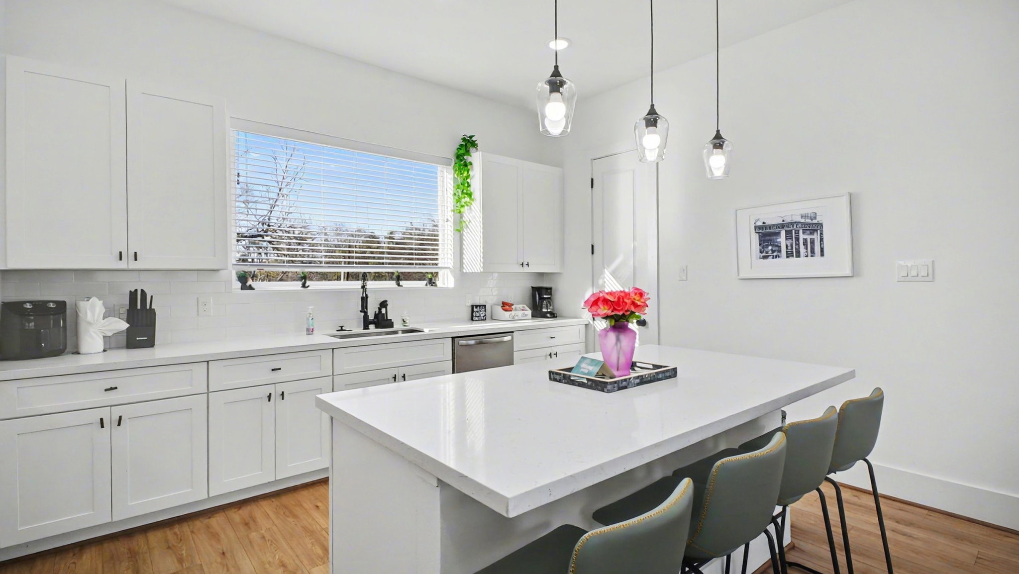 2802 Tierwester Street Houston, TX 77004 - Photo 15 of 35 a kitchen with a dining table chairs and white cabinets