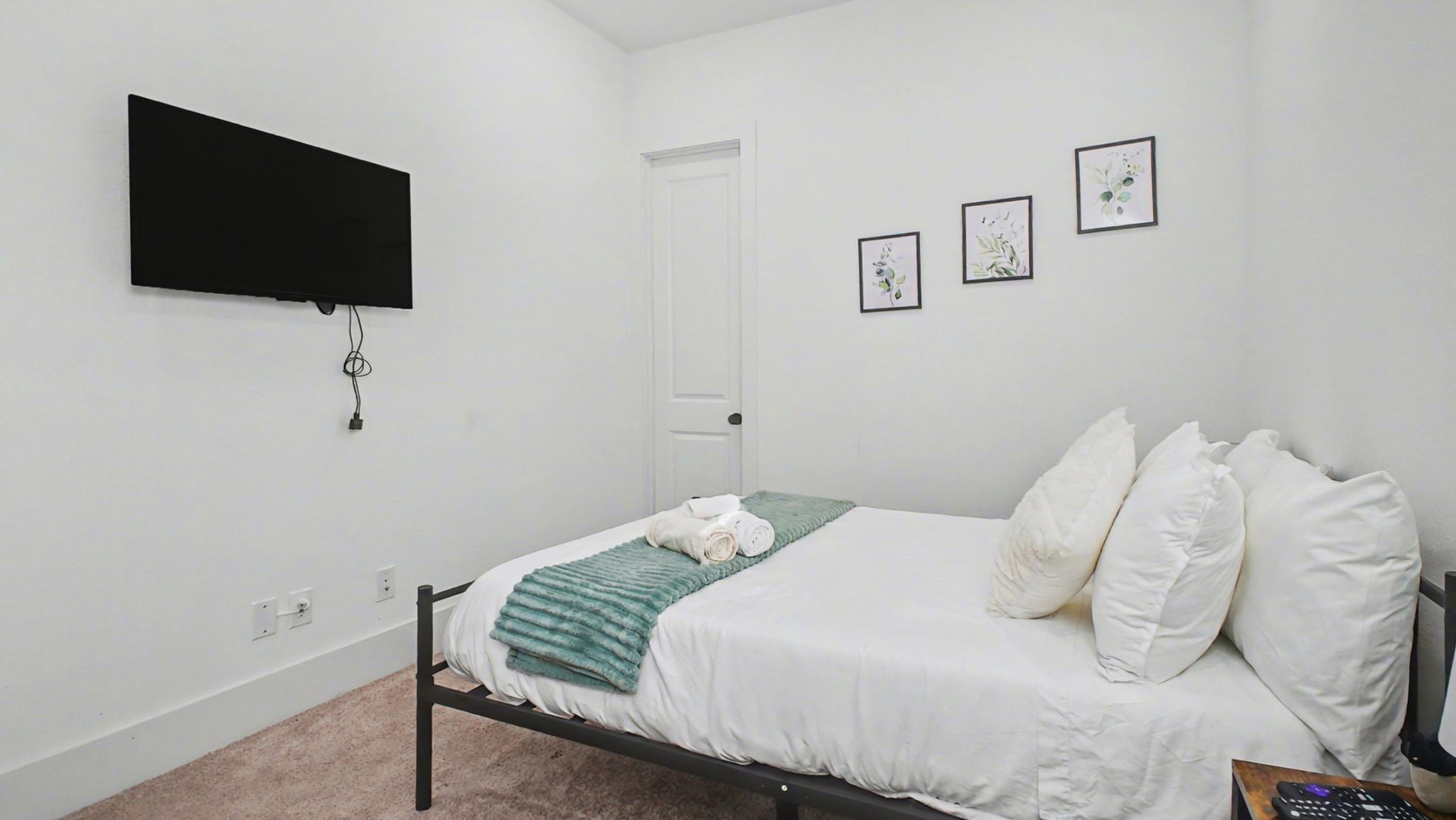 2802 Tierwester Street Houston, TX 77004 - Photo 6 of 35 a bedroom with a bed and a flat screen tv