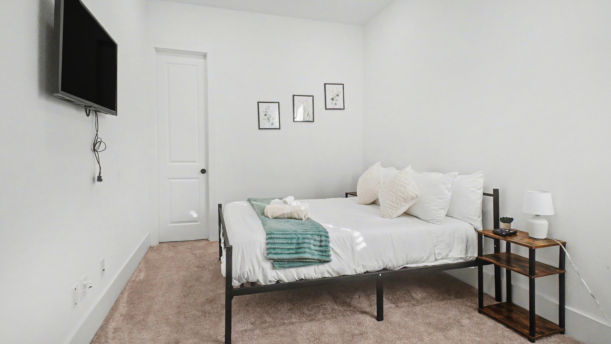 2802 Tierwester Street Houston, TX 77004 - Photo 7 of 35 a bedroom with a bed and a flat screen tv