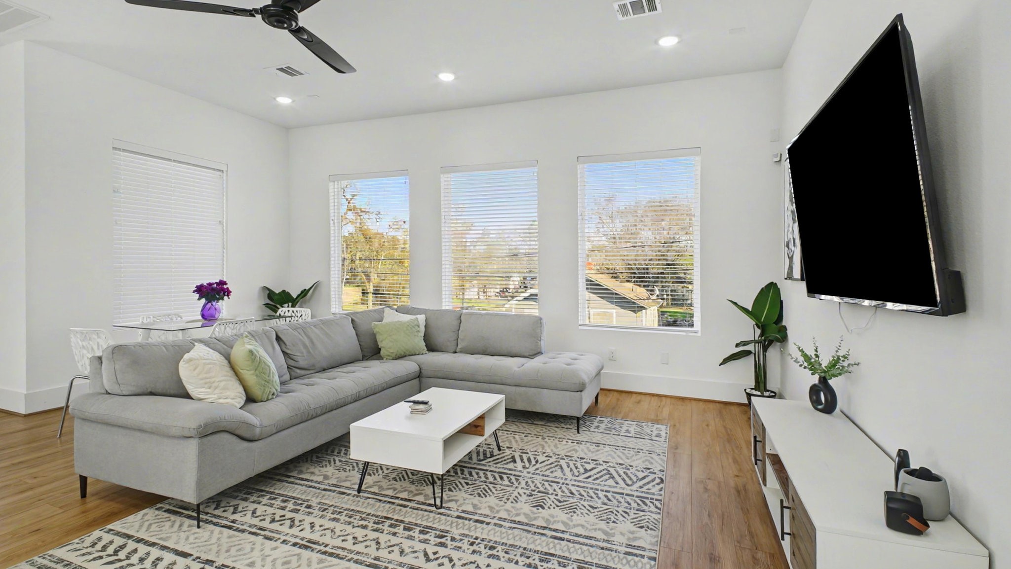 2802 Tierwester Street Houston, TX 77004 - Photo 9 of 35 a living room with furniture a flat screen tv and a window