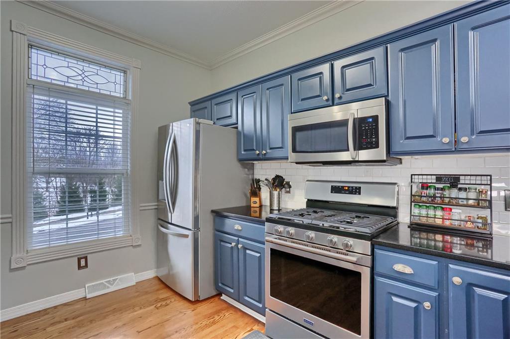 201 Beech Street Gibsonia, PA 15044 - Photo 5 of 49 a kitchen with granite countertop wooden cabinets stainless steel appliances and a window
