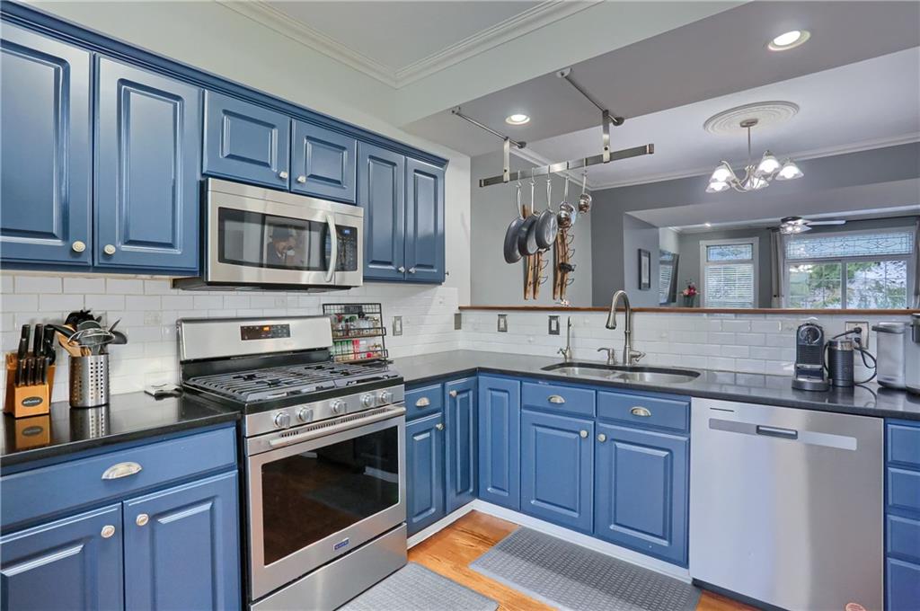 201 Beech Street Gibsonia, PA 15044 - Photo 6 of 49 a kitchen with stainless steel appliances granite countertop wooden cabinets stove top oven and sink