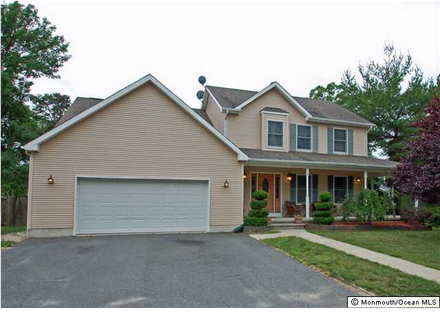 2314 Hollywood Road Point Pleasant, NJ 08742 - Photo 1 of 3 a front view of a house with a yard and garage