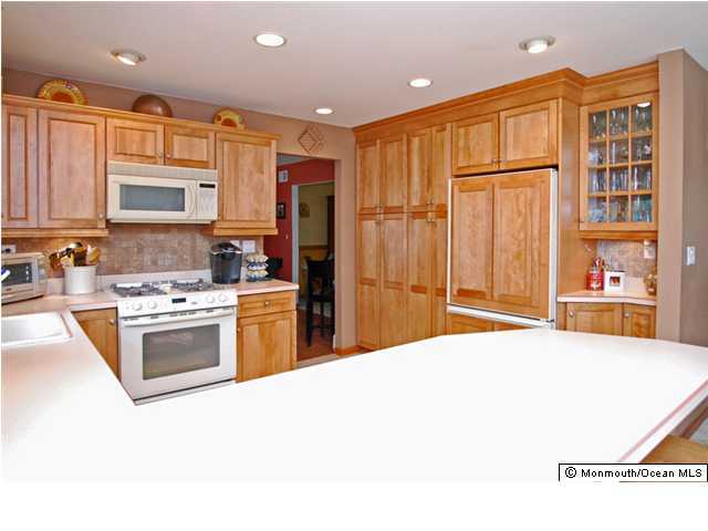 2314 Hollywood Road Point Pleasant, NJ 08742 - Photo 3 of 3 a kitchen with stainless steel appliances granite countertop a stove top oven a sink dishwasher and a refrigerator with wooden floor