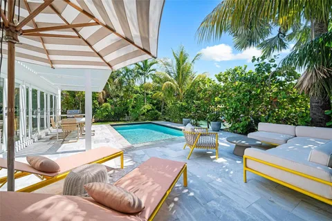 a view of a patio with couches table and chairs potted plants and palm tree
