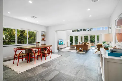 a bedroom with a bed and glass window