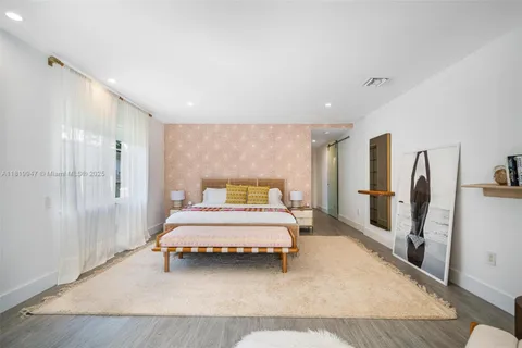 a bathroom with a granite countertop sink mirror and a bathtub