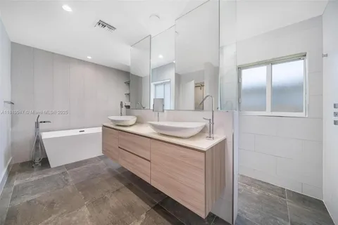 a bathroom with a granite countertop sink mirror and vanity