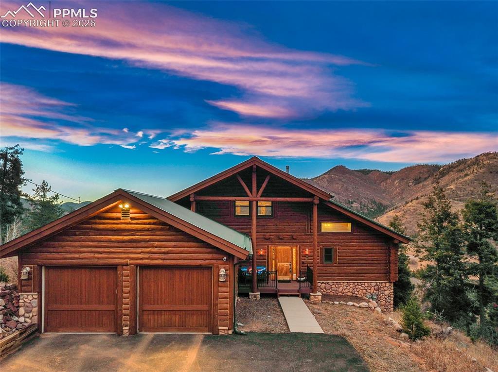 9110 Mountain Road Cascade, CO 80809 - Photo 45 of 49 a front view of a house with a yard