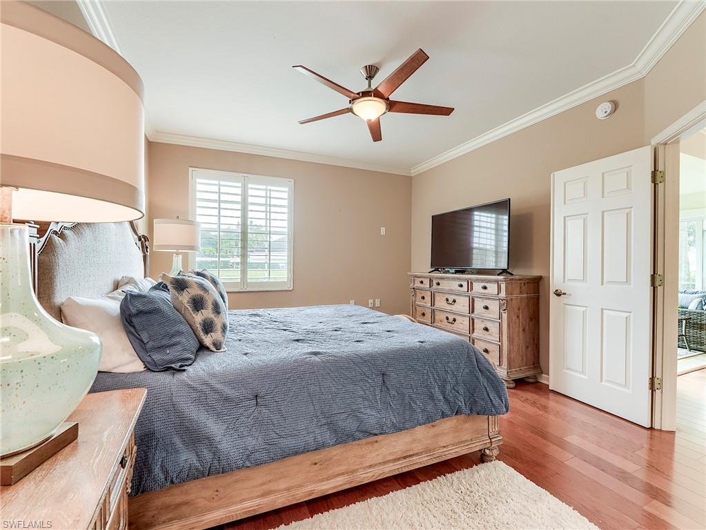 22921 Rosedale Drive, Unit 102 Estero, FL 34135 - Photo 22 of 33 a bedroom with a bed and a flat screen tv