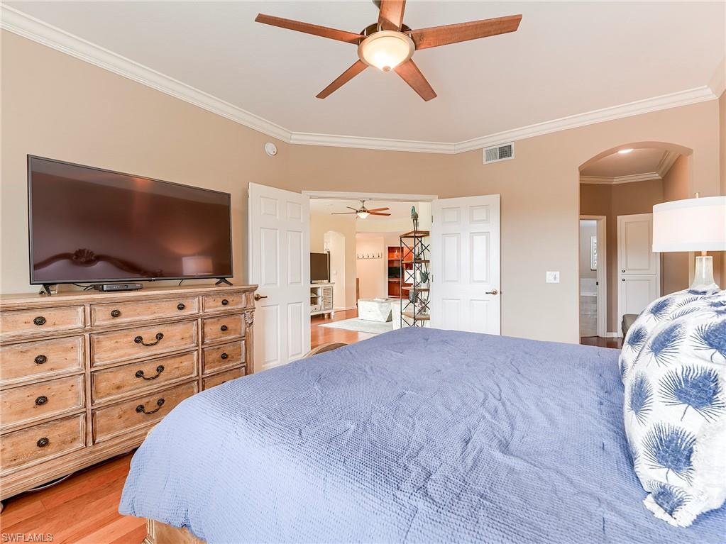 22921 Rosedale Drive, Unit 102 Estero, FL 34135 - Photo 23 of 33 a bedroom with a bed and a flat screen tv