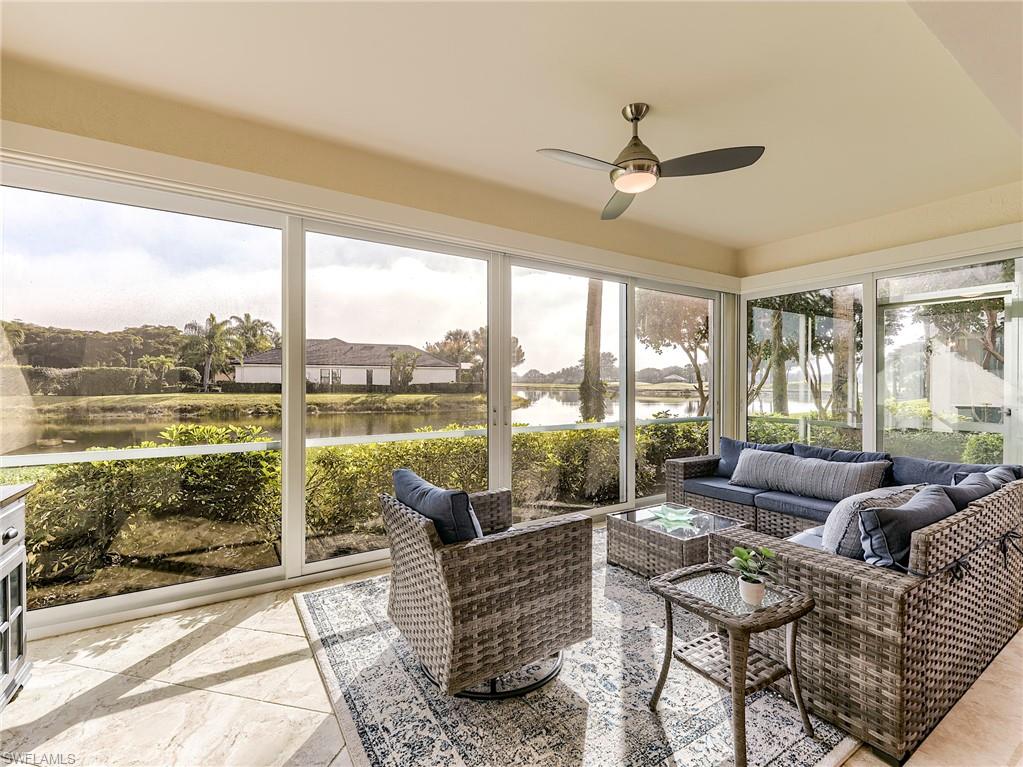 22921 Rosedale Drive, Unit 102 Estero, FL 34135 - Photo 4 of 33 a living room with furniture and floor to ceiling windows
