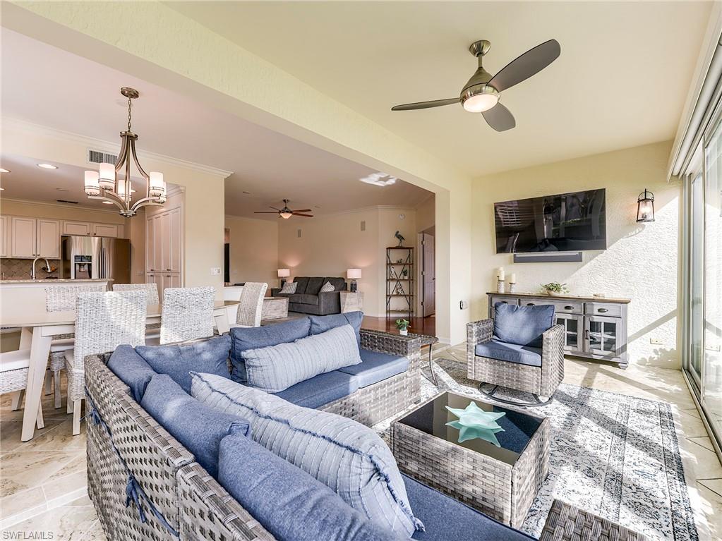 22921 Rosedale Drive, Unit 102 Estero, FL 34135 - Photo 6 of 33 a living room with furniture a flat screen tv and a fireplace