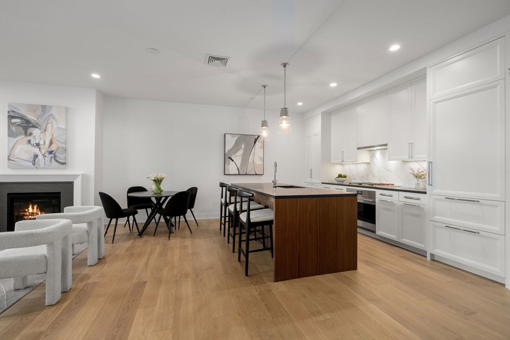 100 Linden Street, Unit 102 Wellesley, MA 02482 - Photo 1 of 30 a kitchen with cabinets and wooden floor