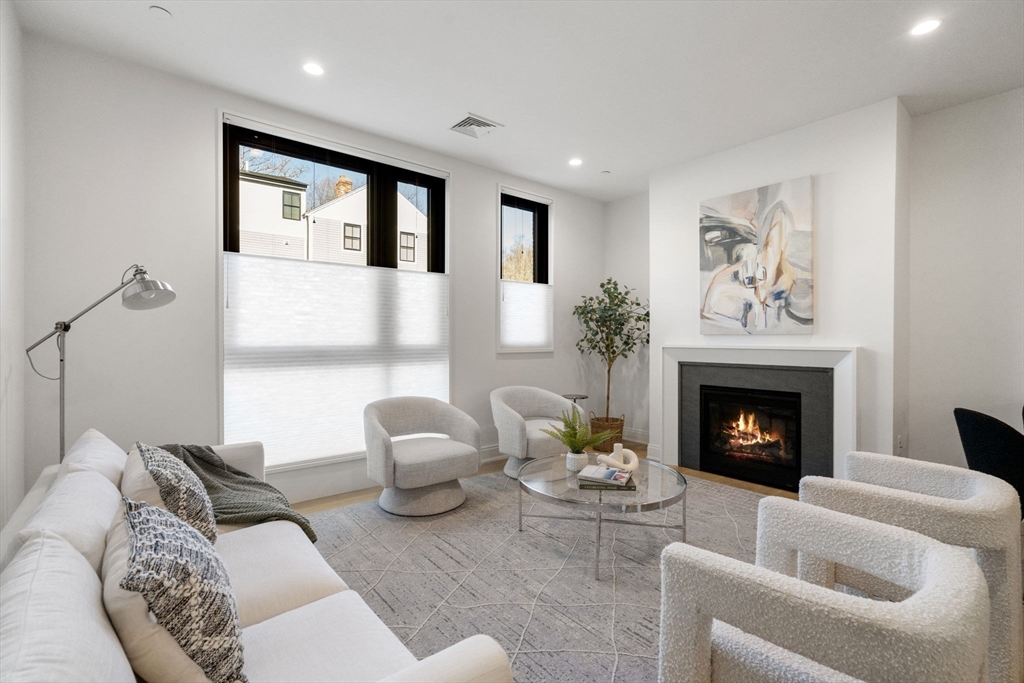100 Linden Street, Unit 102 Wellesley, MA 02482 - Photo 6 of 30 a living room with furniture and a fireplace