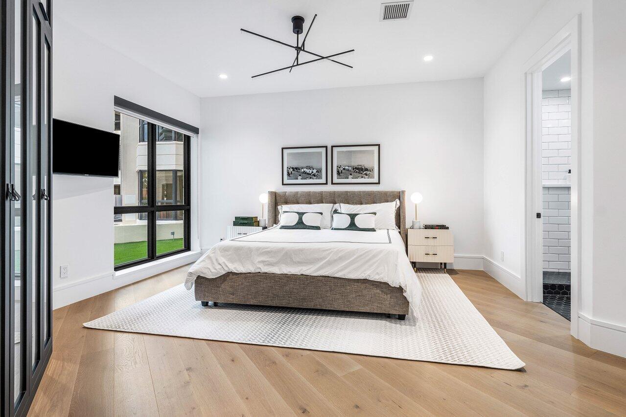 7383 Orangewood Lane, Unit 501 Boca Raton, FL 33433 - Photo 31 of 67 a spacious bedroom with a bed and a flat screen tv