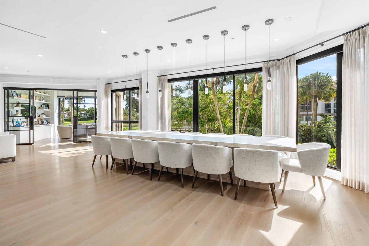 7383 Orangewood Lane, Unit 501 Boca Raton, FL 33433 - Photo 9 of 67 a dining room with wooden floor and large windows