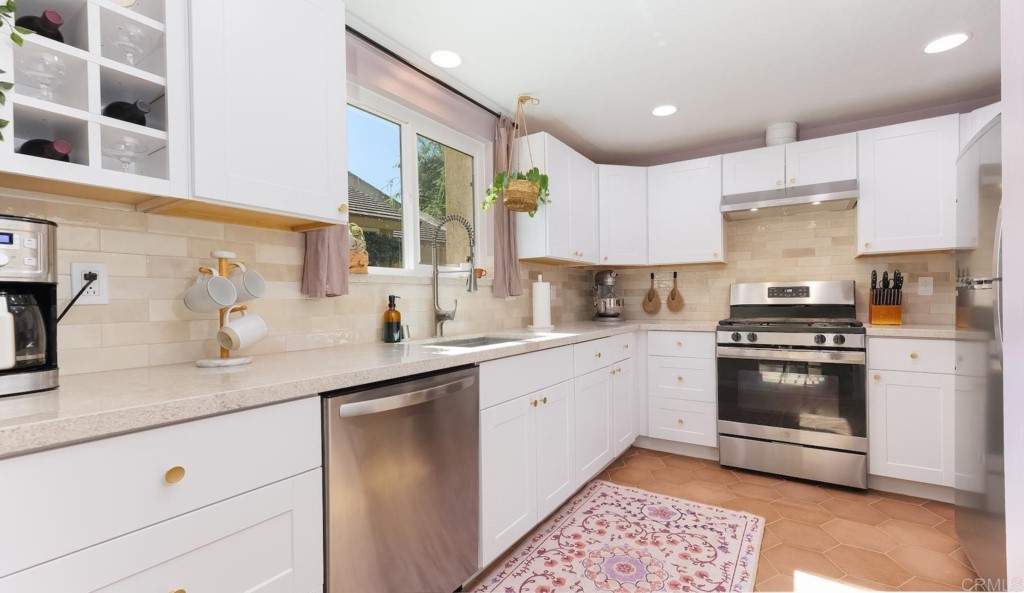 322 Ivy Lane Fallbrook, CA 92028 - Photo 11 of 35 a kitchen with stainless steel appliances granite countertop a sink and cabinets
